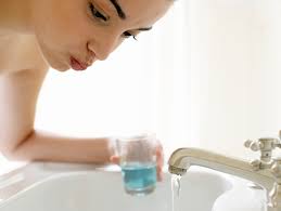 rinsing mouth with mouthwash